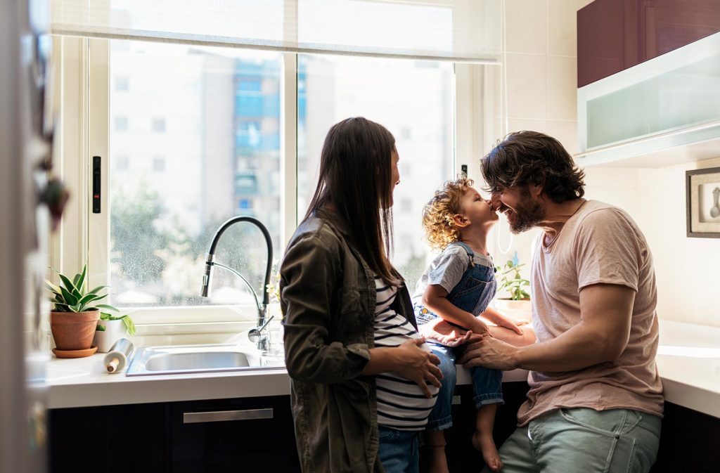 Image of a family of 3 in a kitchen